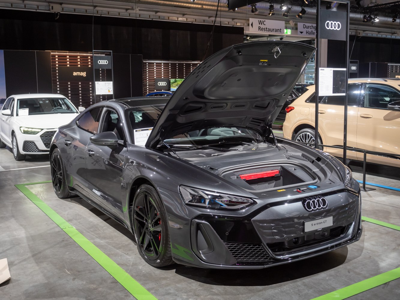Front trunk open on a sleek electric sports coupe