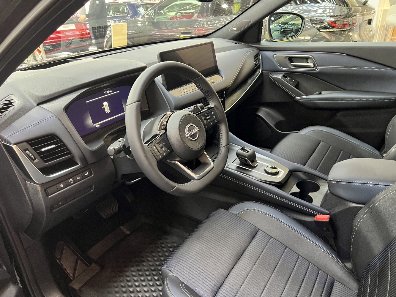 Dashboard, steering wheel, and center console with digital displays and modern design
