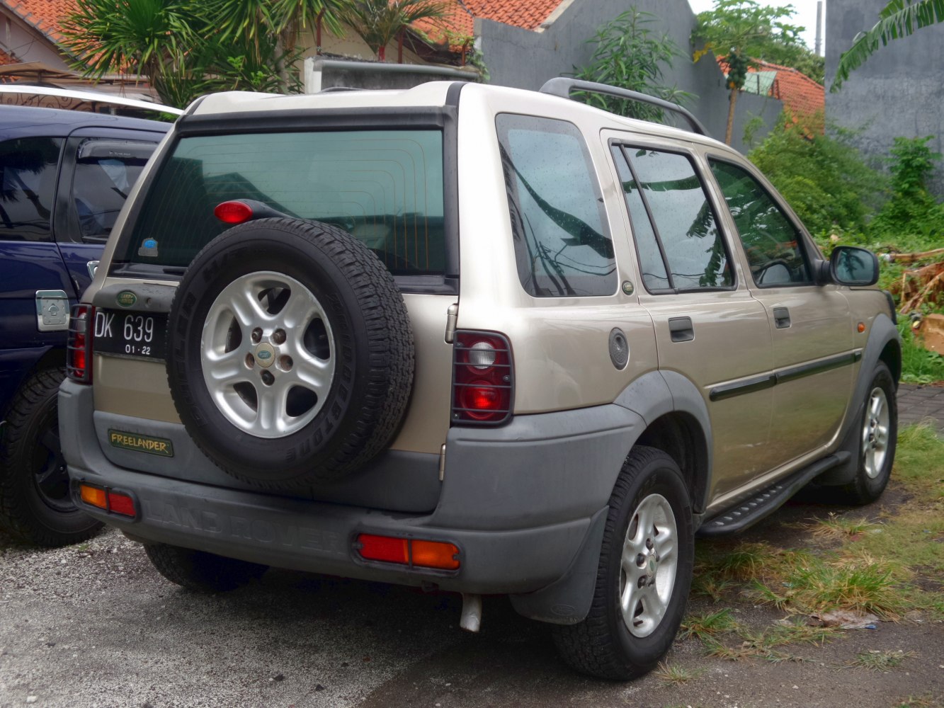 Rear angled view of SUV with rear spare tire and tail lights