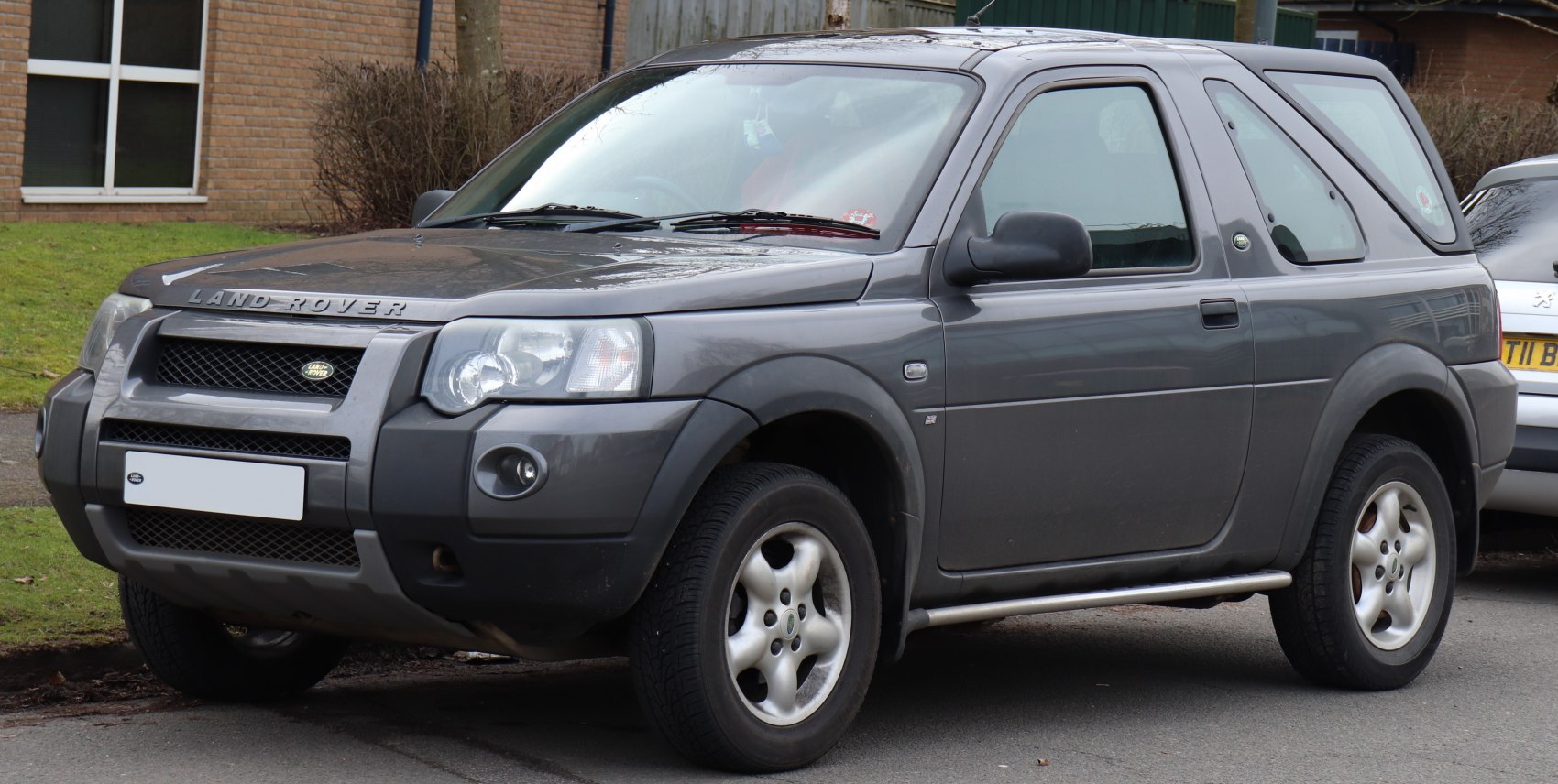 Front and side view of compact rugged SUV with hard top