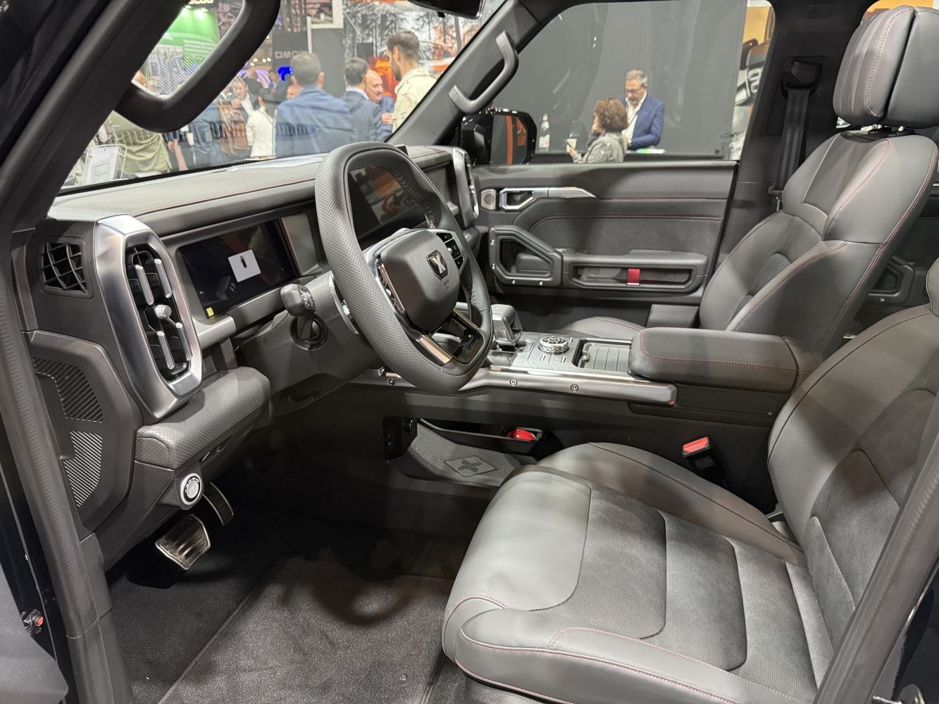 Modern car interior dashboard and steering wheel with premium seats