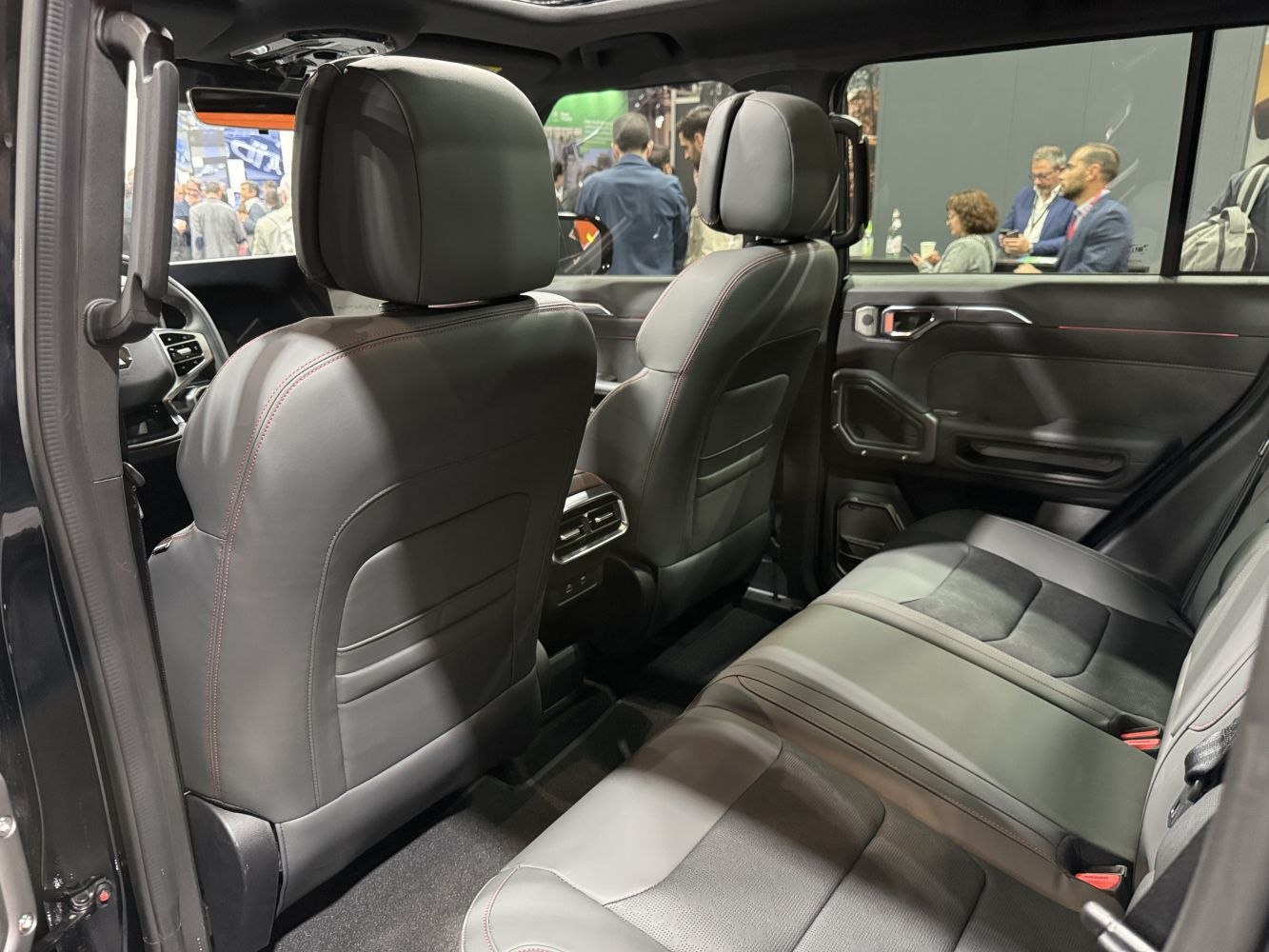Spacious rear seating with leather upholstery and modern door panel design.