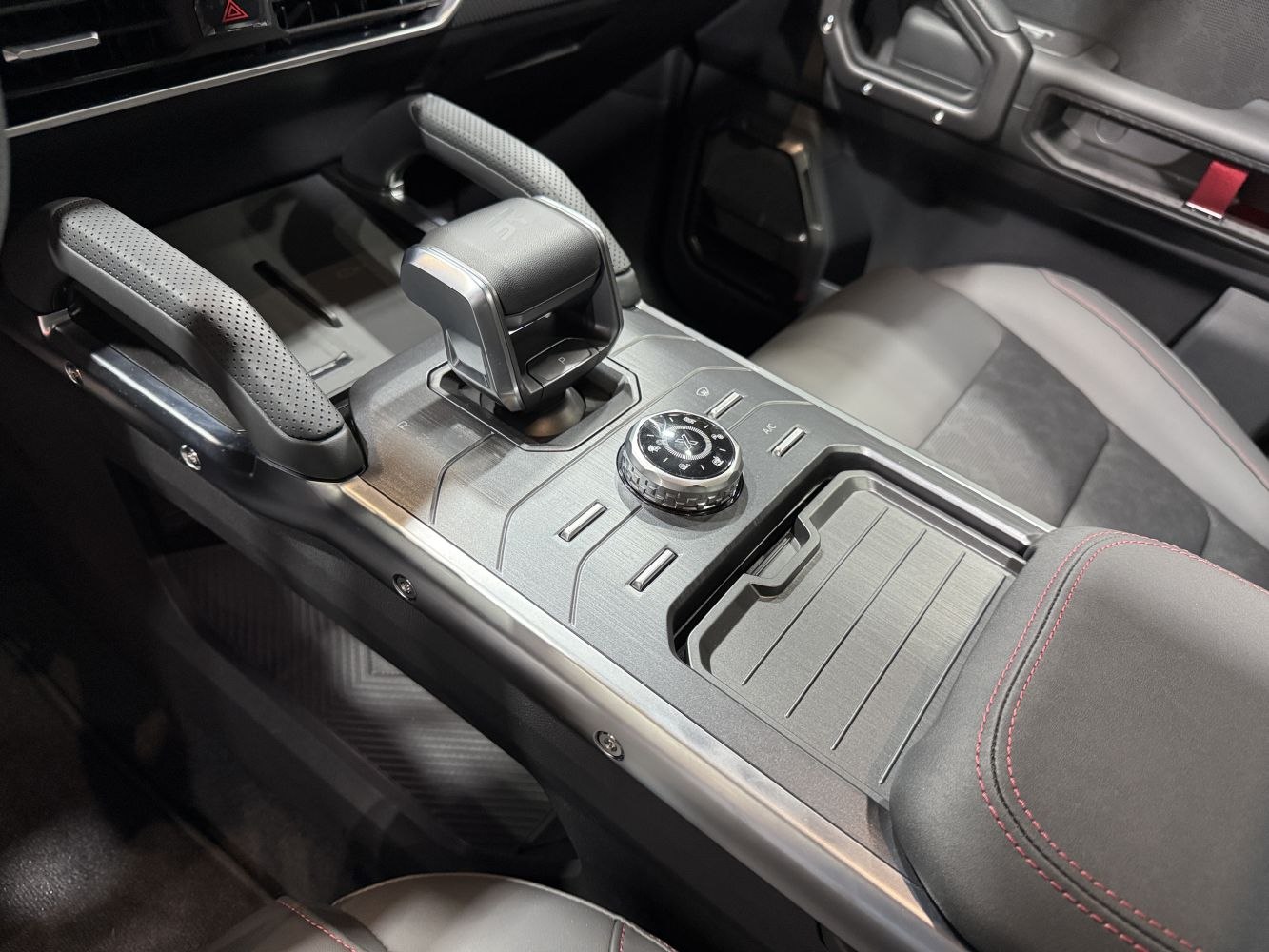 Center console featuring gear selector and control dial