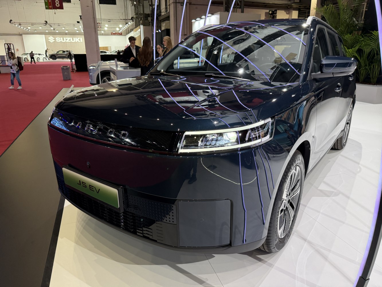 Sleek EV front fascia with LED headlights and aerodynamic SUV side profile