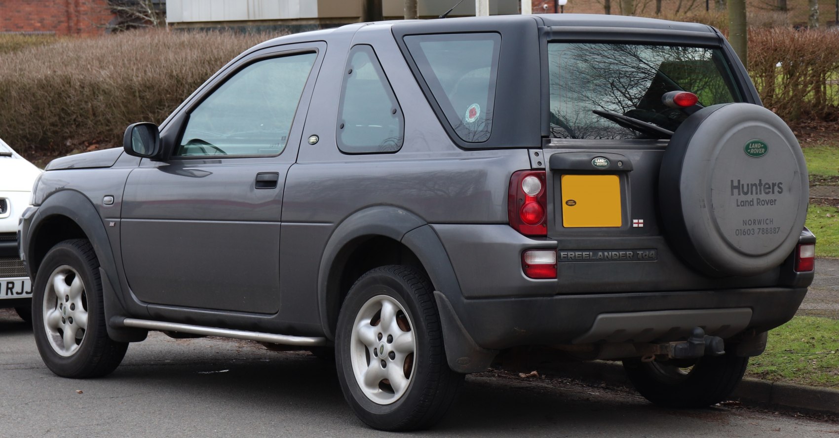 Rear side view with spare tire cover and alloy wheels