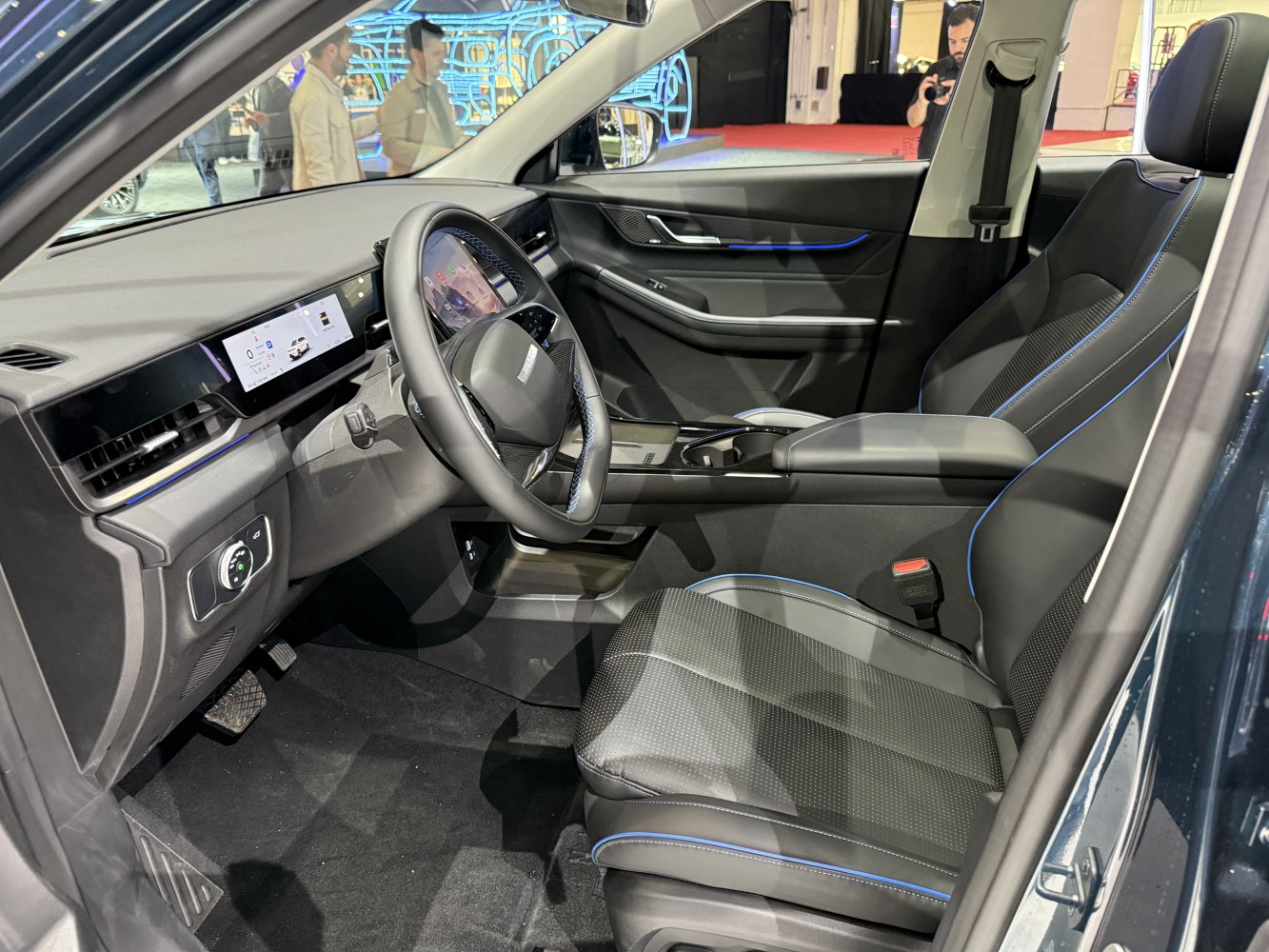 Digital dashboard and modern front seats with blue stitching
