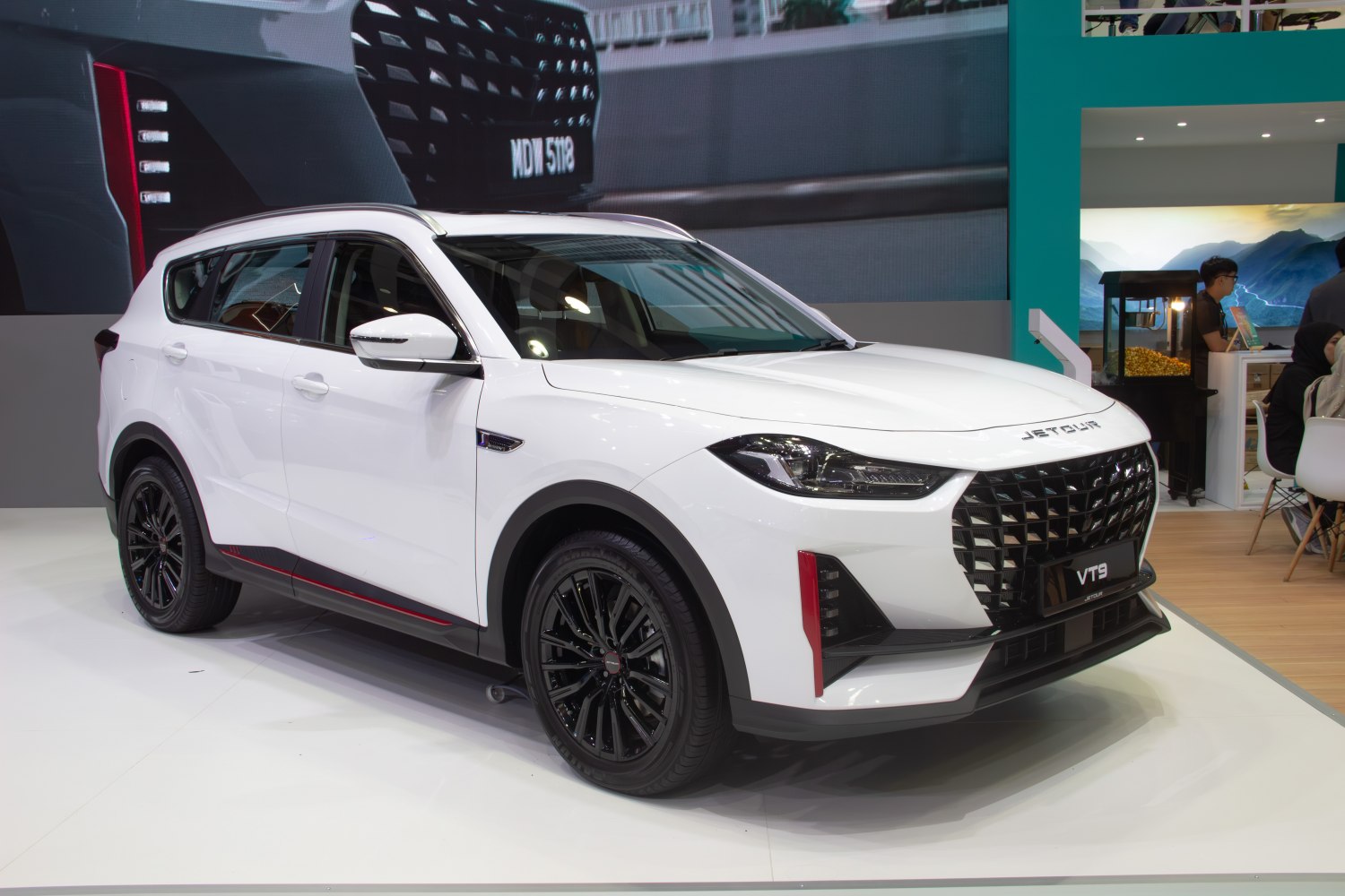 Front-side view of white SUV with black alloy wheels