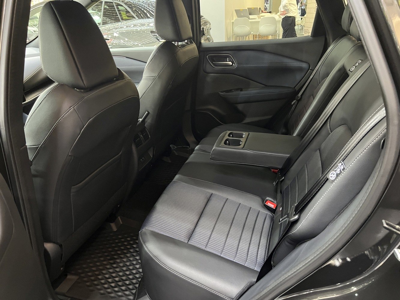 Rear seat interior with leather upholstery and cup holders