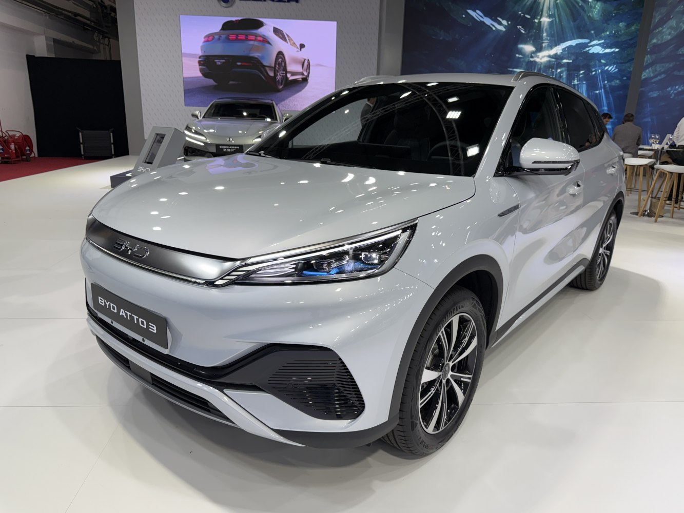 Front-side view of white electric SUV with sleek headlights and aerodynamic design