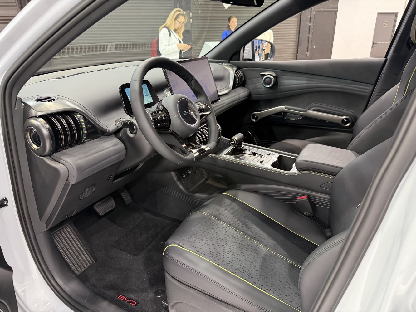 Modern steering wheel with digital displays and premium leather seats.
