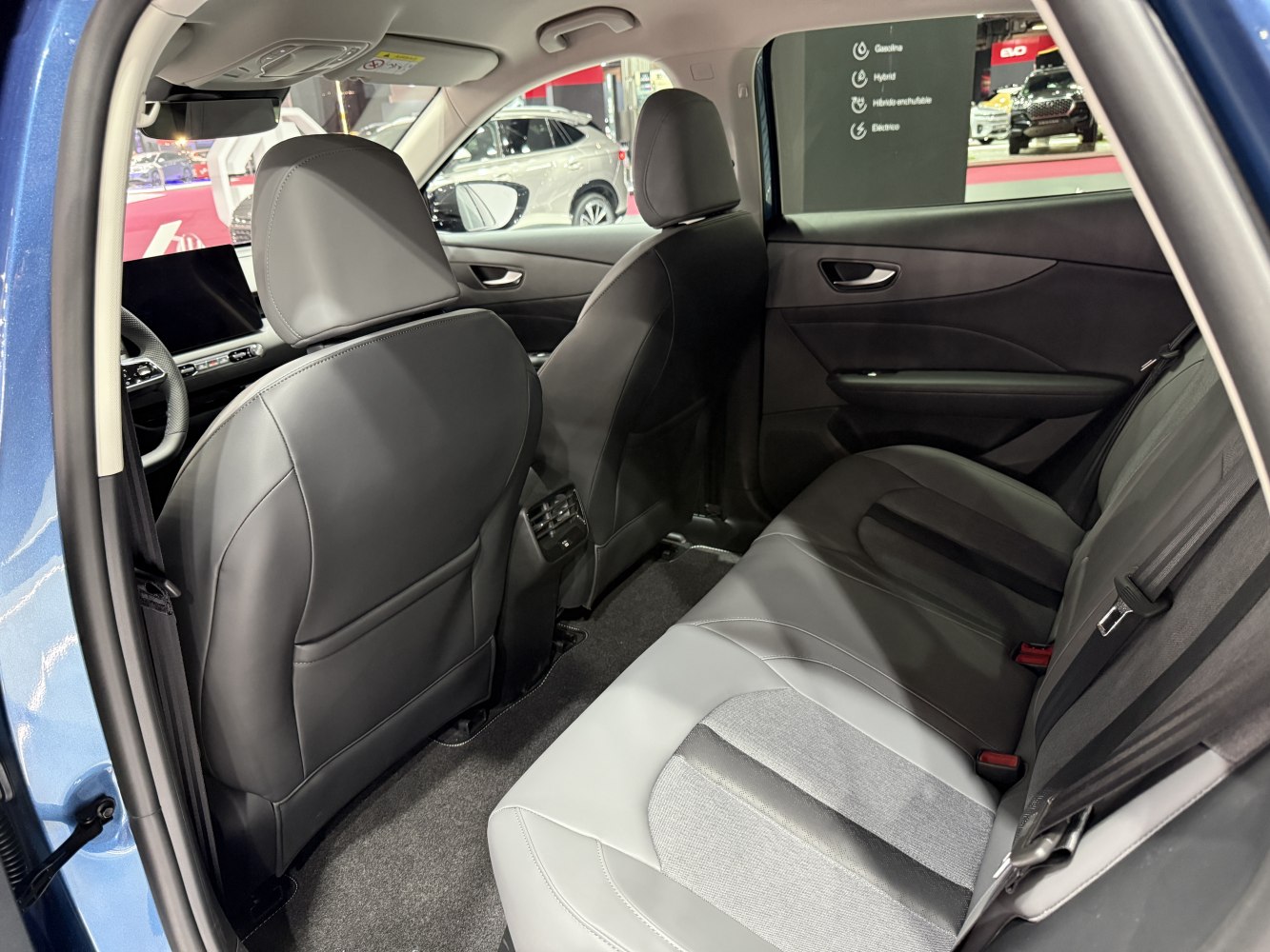 Modern rear seats and rear cabin space with ventilation vents and door panel.