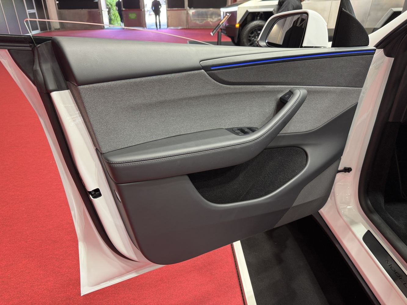 Interior door panel with ambient lighting and control buttons