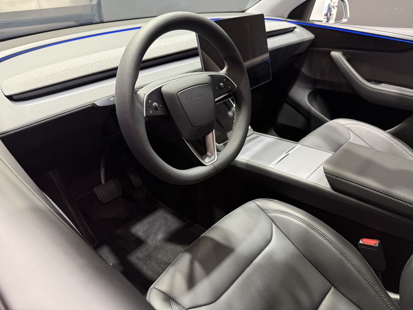 Yoke steering wheel and minimalist dashboard with touchscreen.