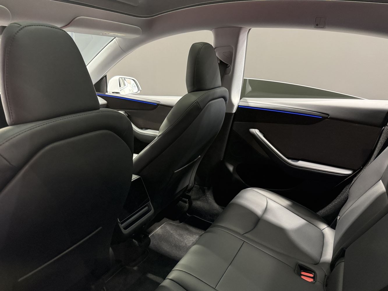Rear black leather seats and door trim with blue ambient lighting