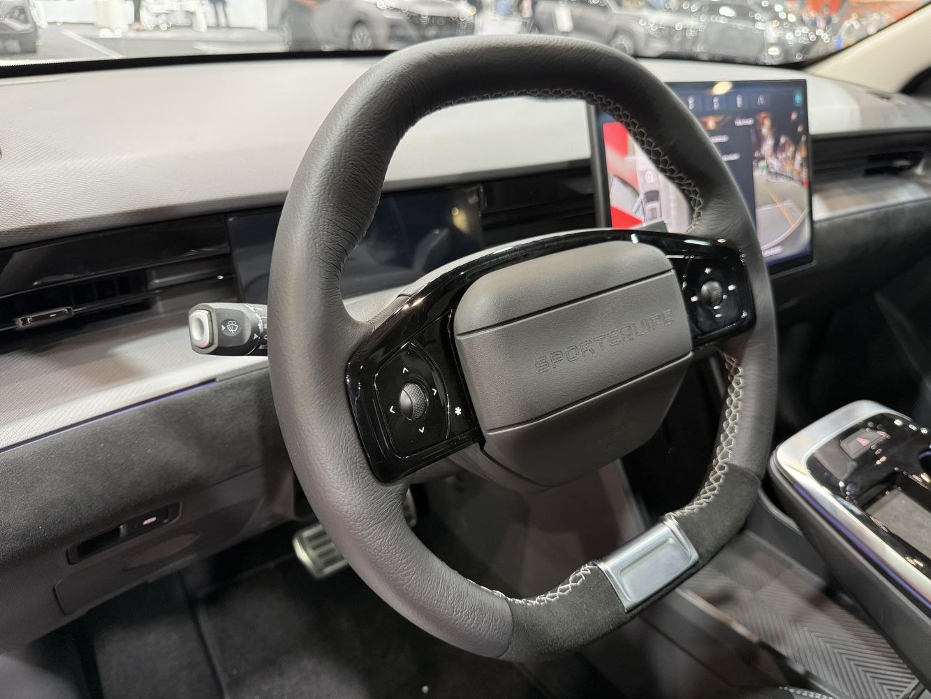 Close-up of multifunction steering wheel and digital dashboard display