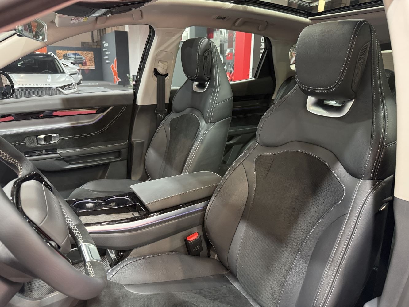 Premium black leather front seats with contrast stitching and ergonomic design