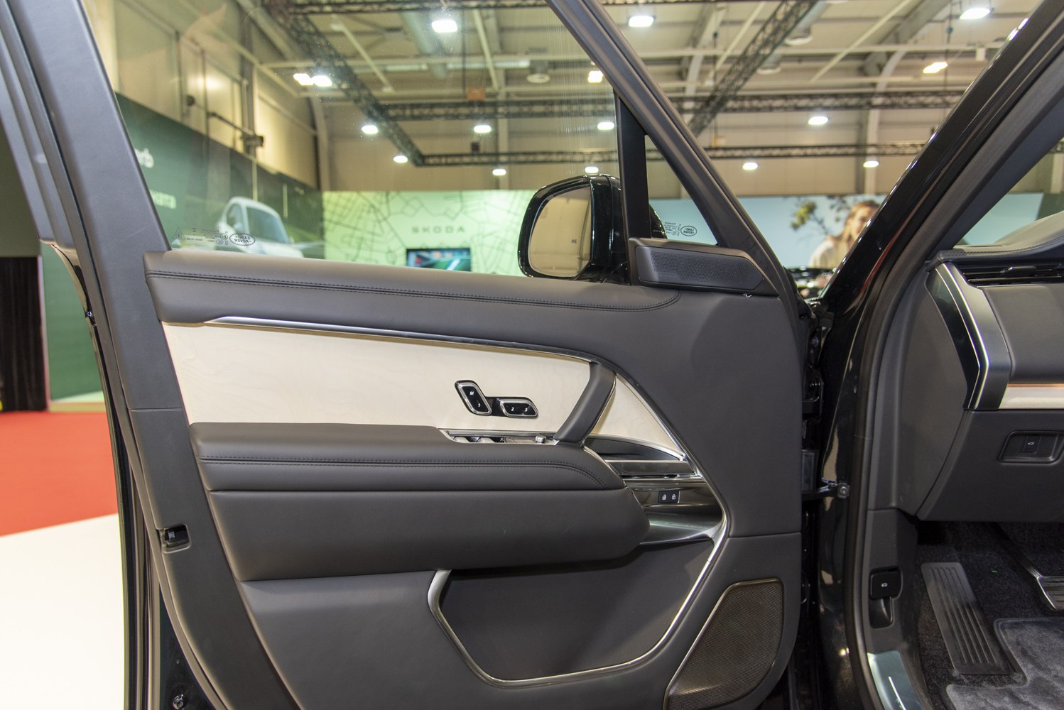 Luxury car door panel with wood trim and memory seat controls