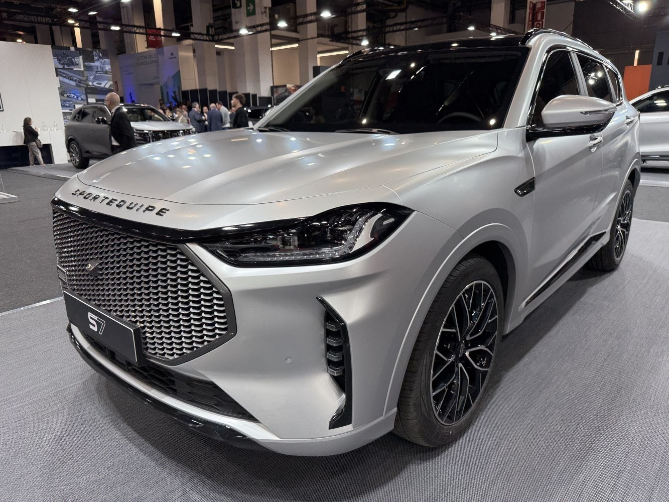 SUV front grille and LED headlights with alloy wheels.