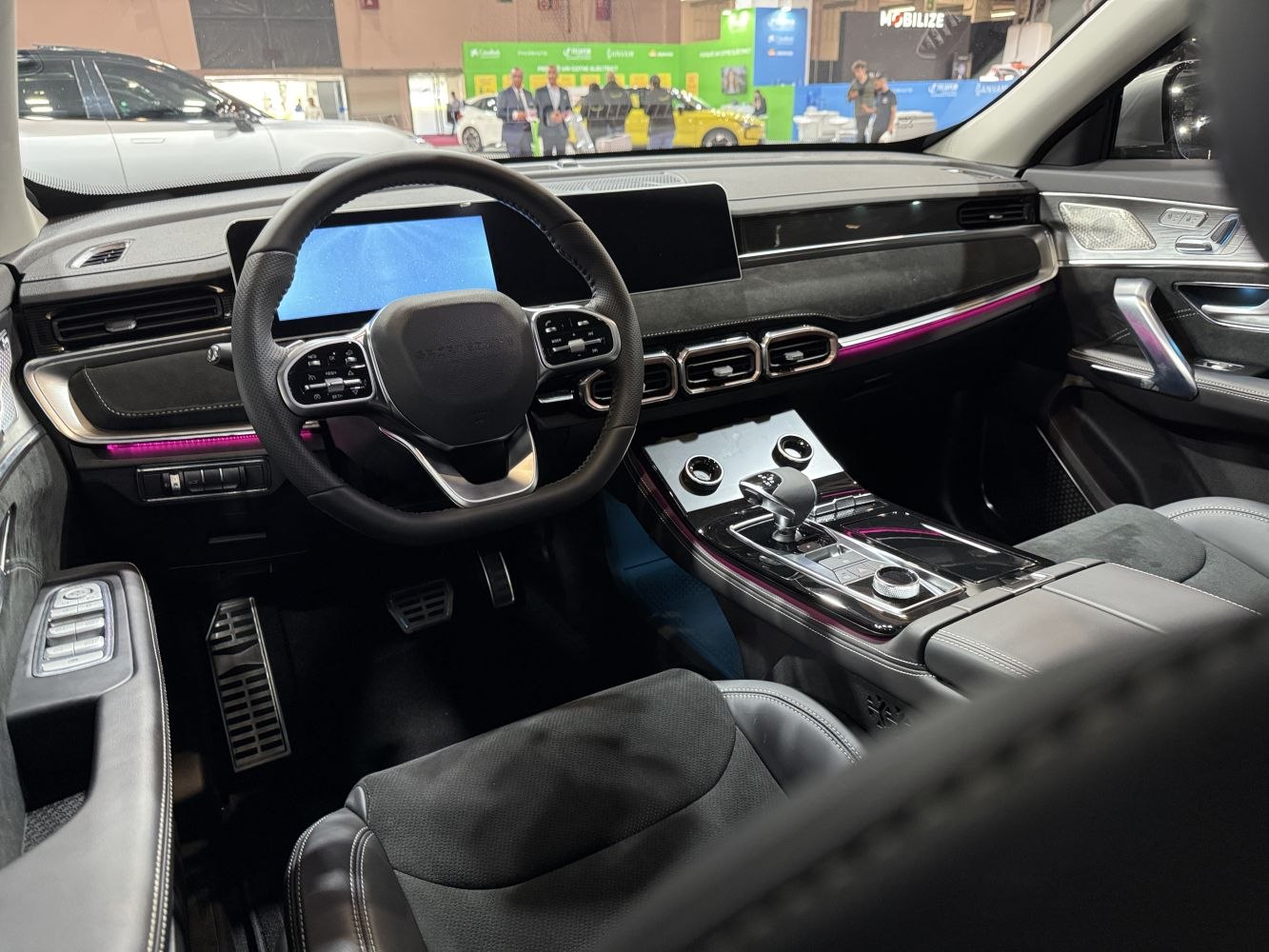 Modern car interior with digital displays and sleek steering wheel