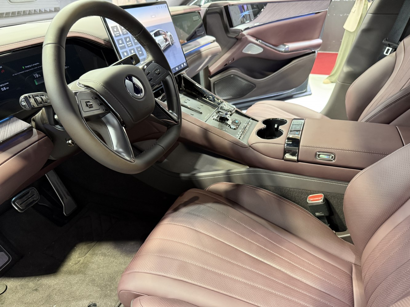Luxury interior with yoke steering, digital dashboard, and plush leather seats