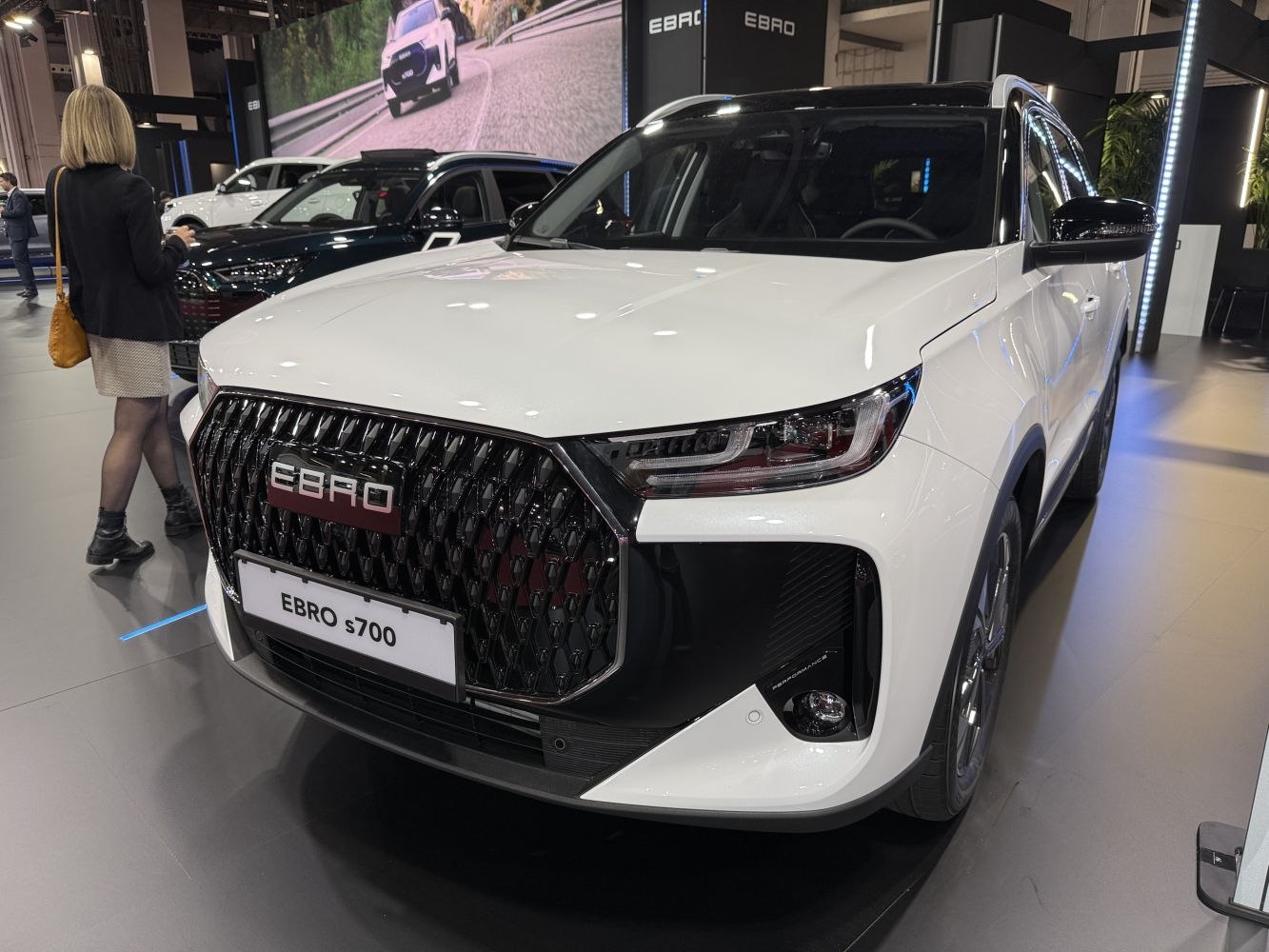 Close-up of front grille and LED headlights on modern vehicle.