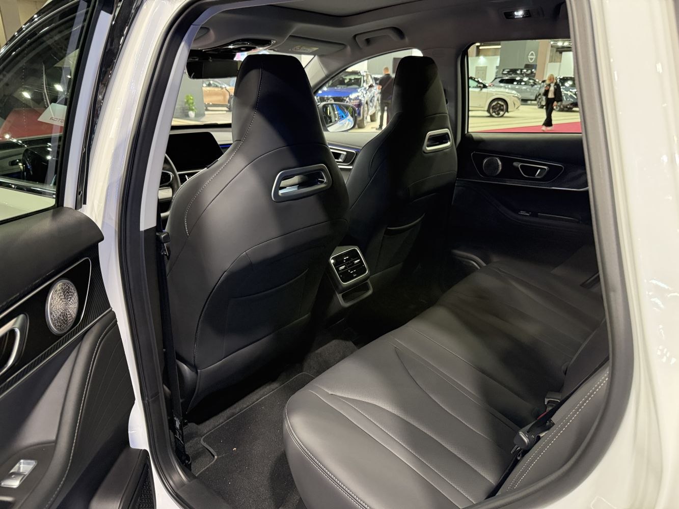 Rear black leather seats with modern door panel and rear air vents