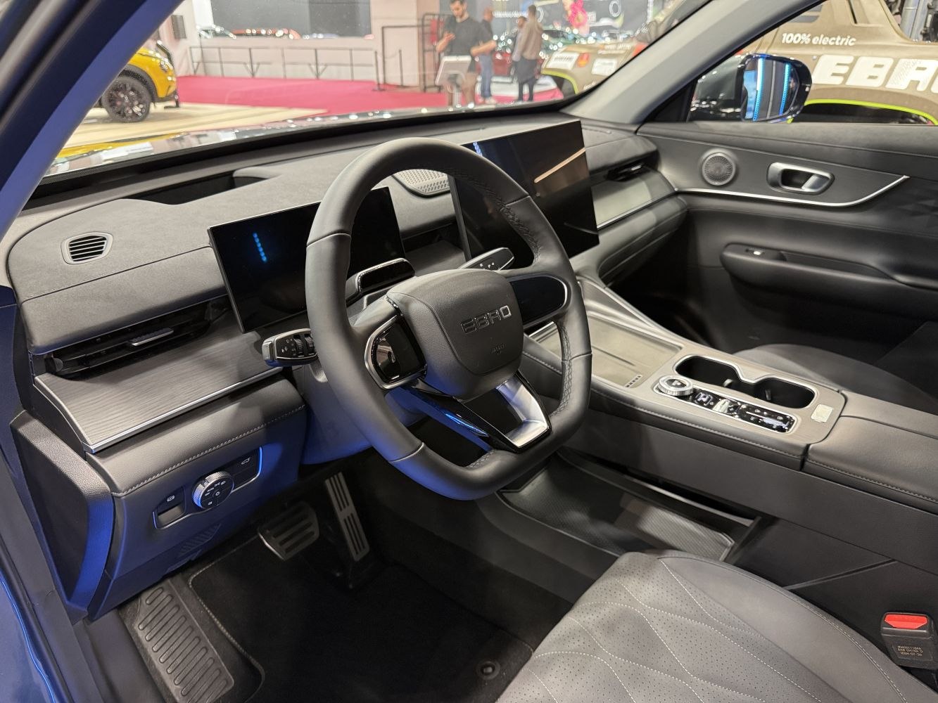 Digital dashboard and modern steering wheel with sleek center console and pedals