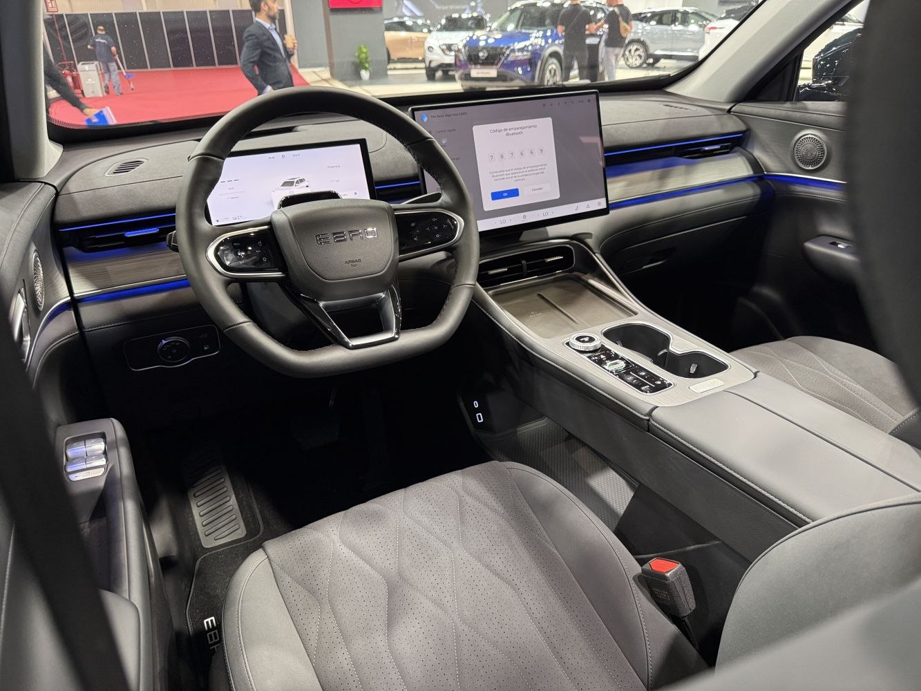 Dual digital displays and modern steering wheel with ambient lighting