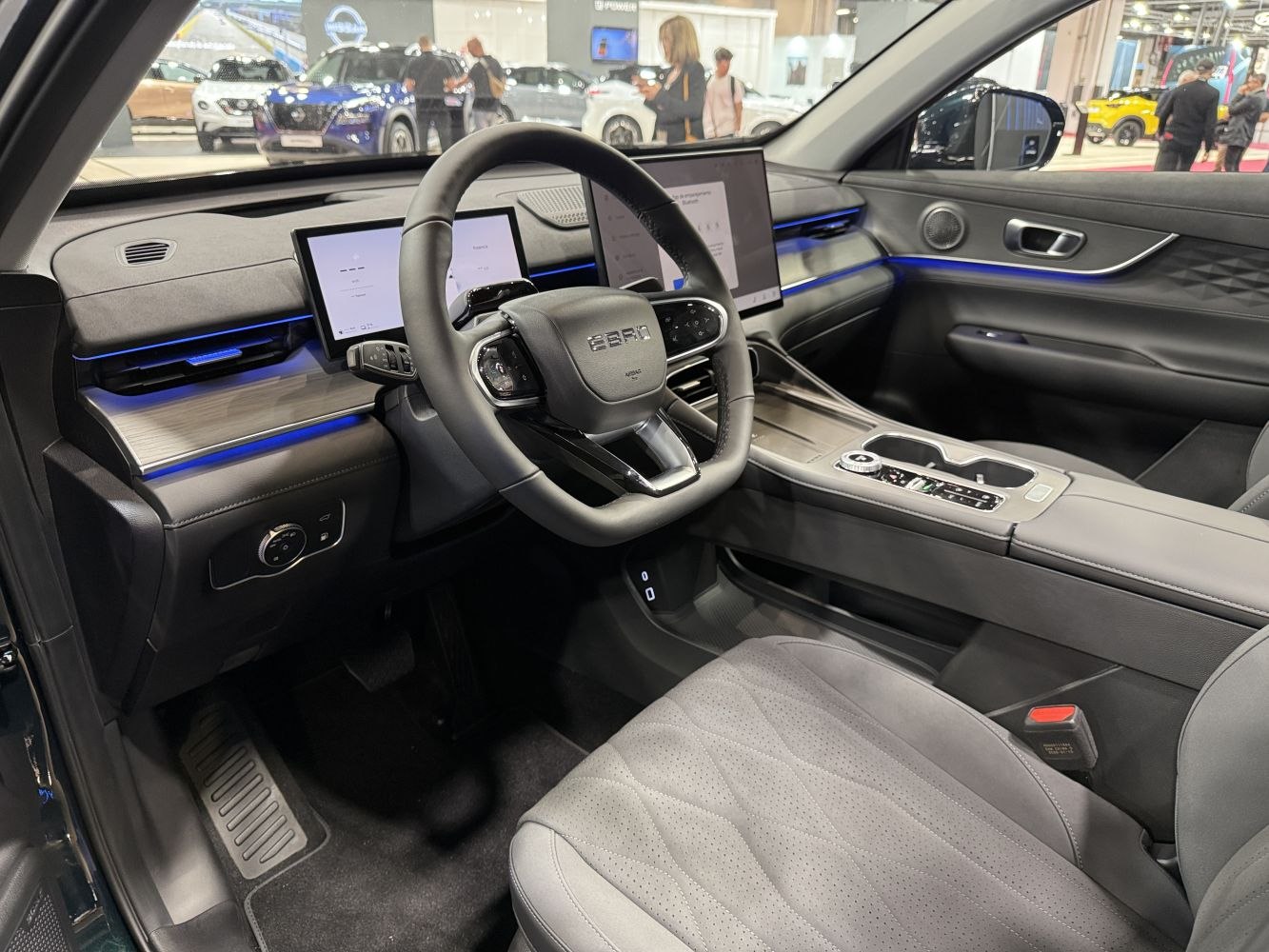 Dual digital displays and ambient blue lighting in a modern vehicle interior