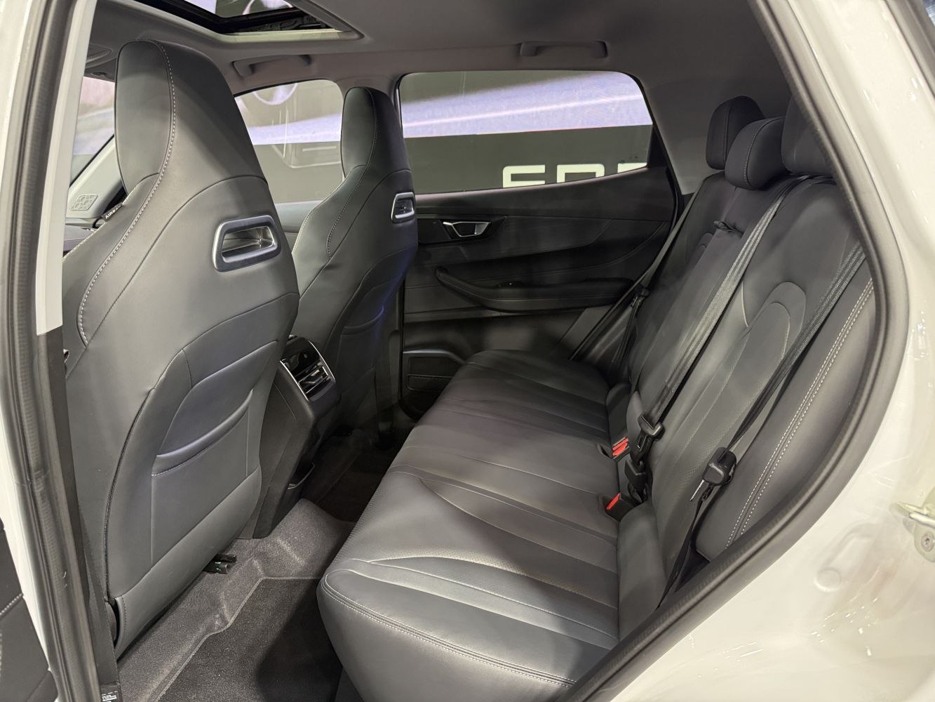 Rear interior with black leather seats and spacious legroom