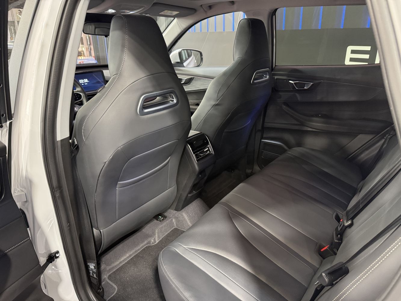 Rear interior with black leather seats and modern cabin features