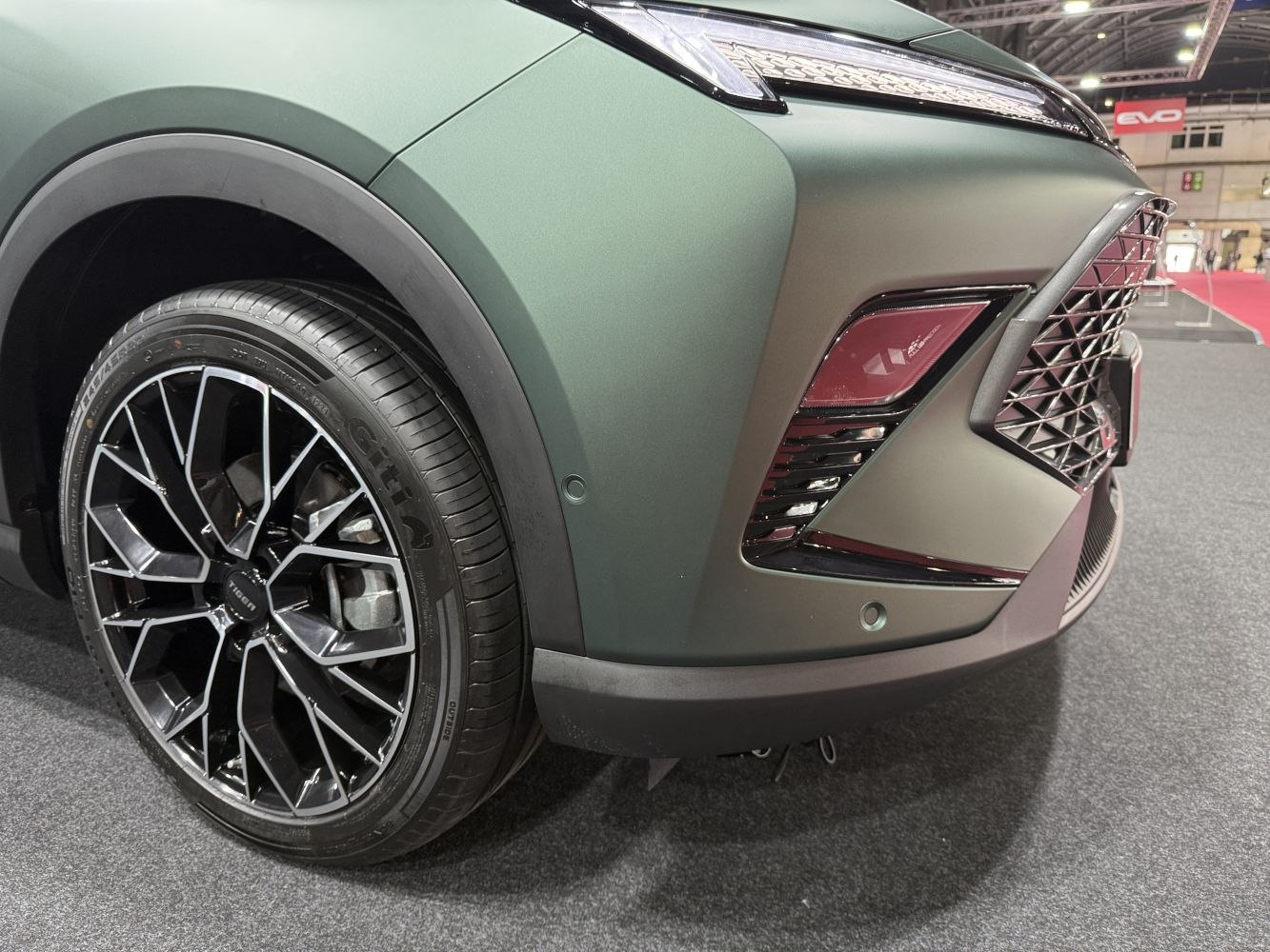 Close-up of front wheel and headlight with modern grille