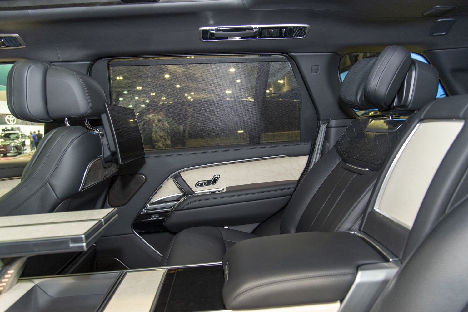 Luxury rear seats with built-in screens and foldable tables