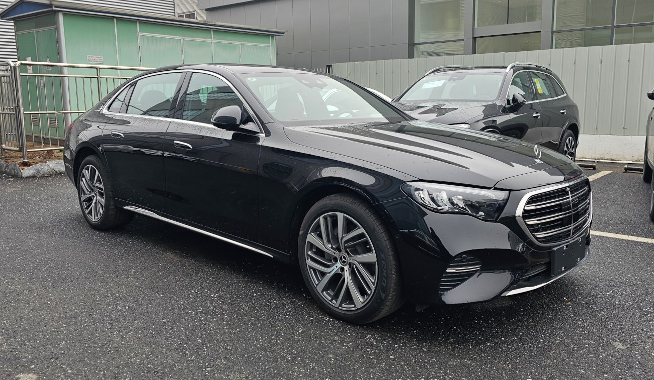 Luxury black sedan with wide grille and multi-spoke alloy wheels