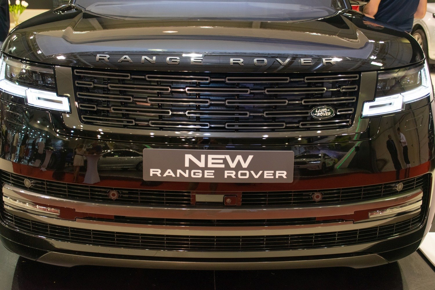 Close-up of front grille and LED headlights with Land Rover emblem