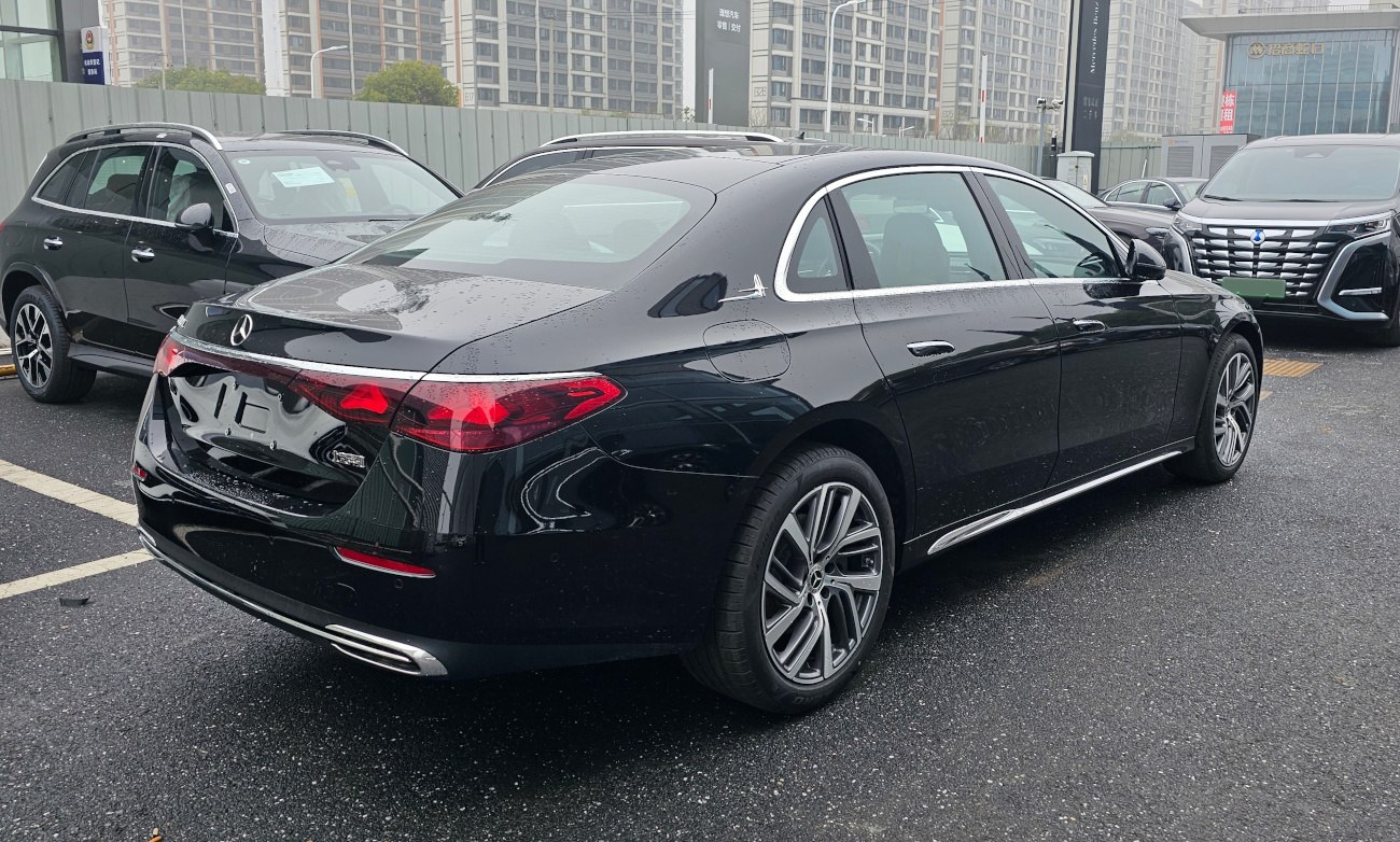 Rear design and distinctive LED taillights of a luxury sedan in rain