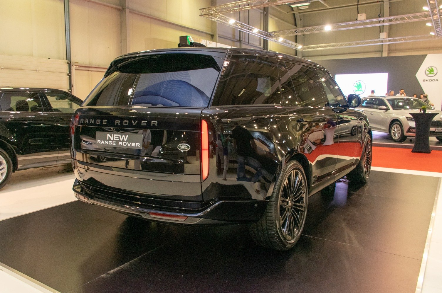 Rear and side view of a sleek black luxury SUV