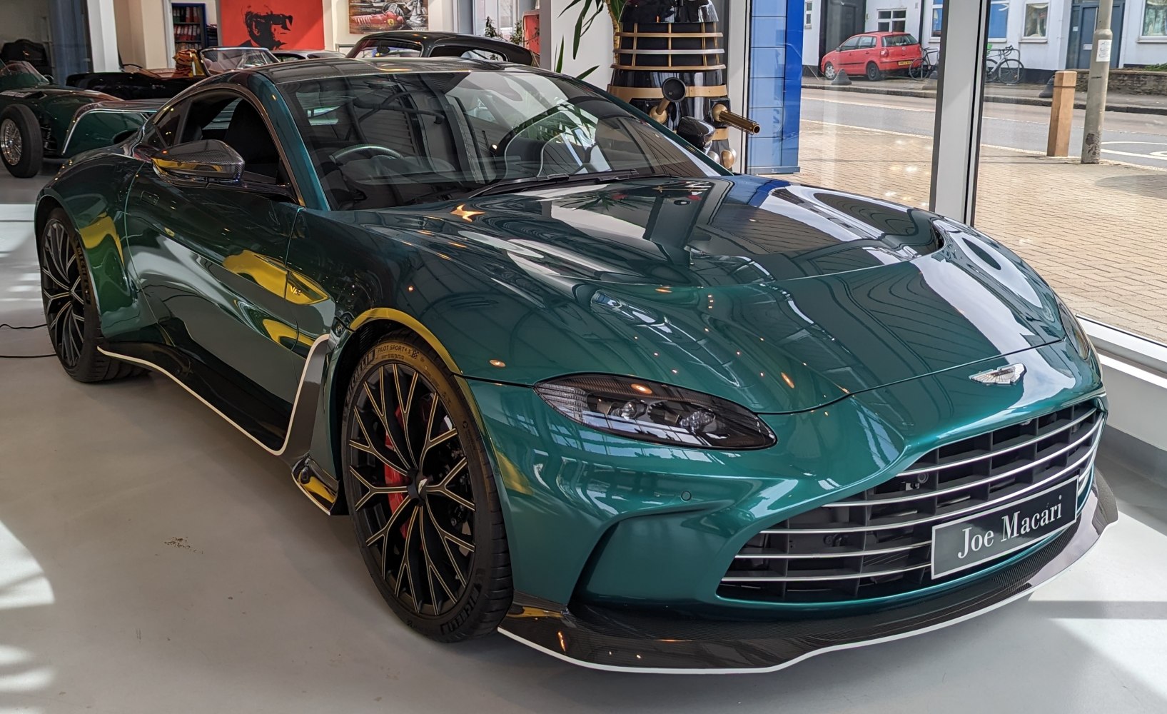 Sleek front fascia and intricate alloy wheel design of a luxury sports coupe