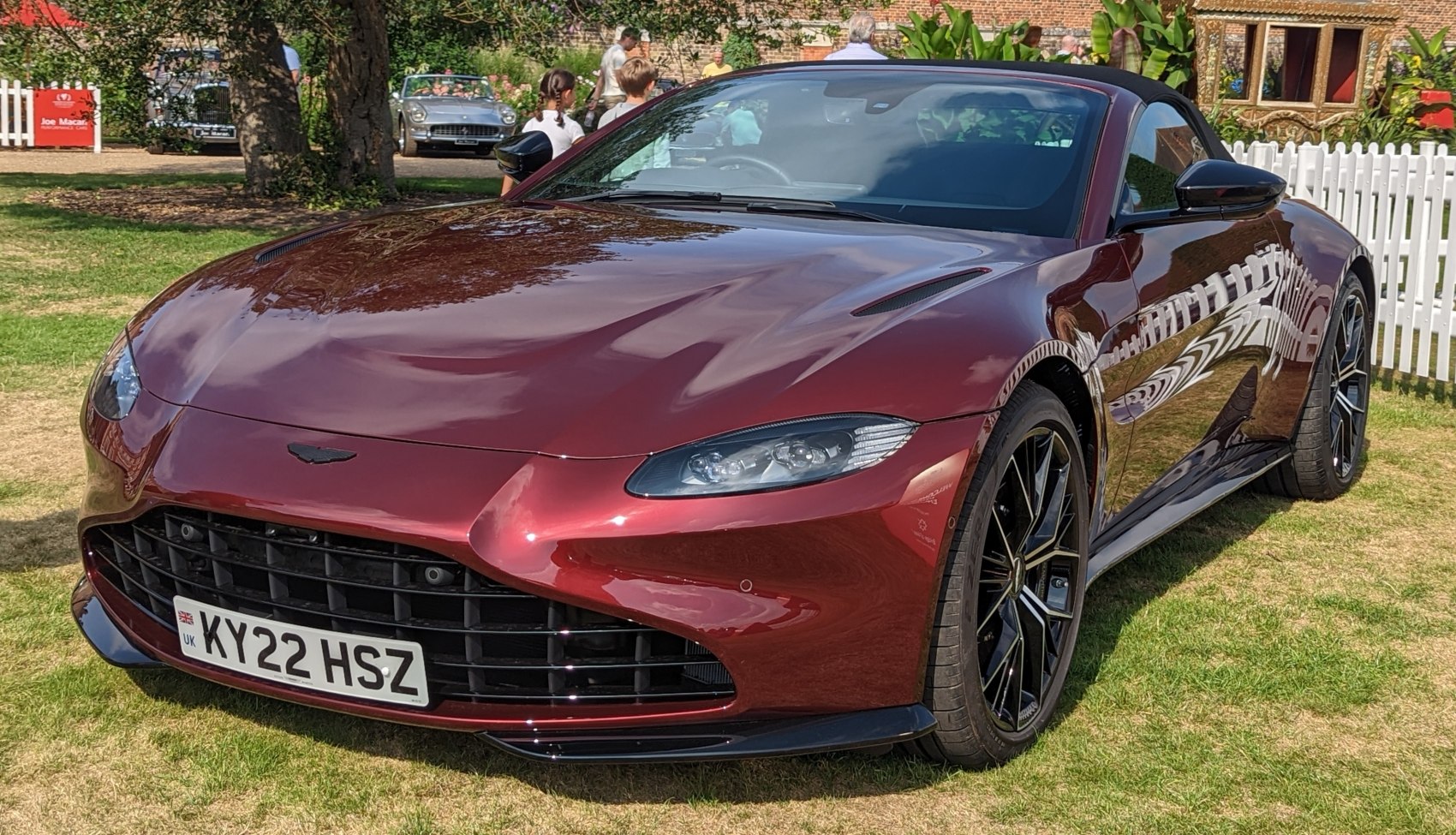 Convertible sports car with prominent front grille and headlights