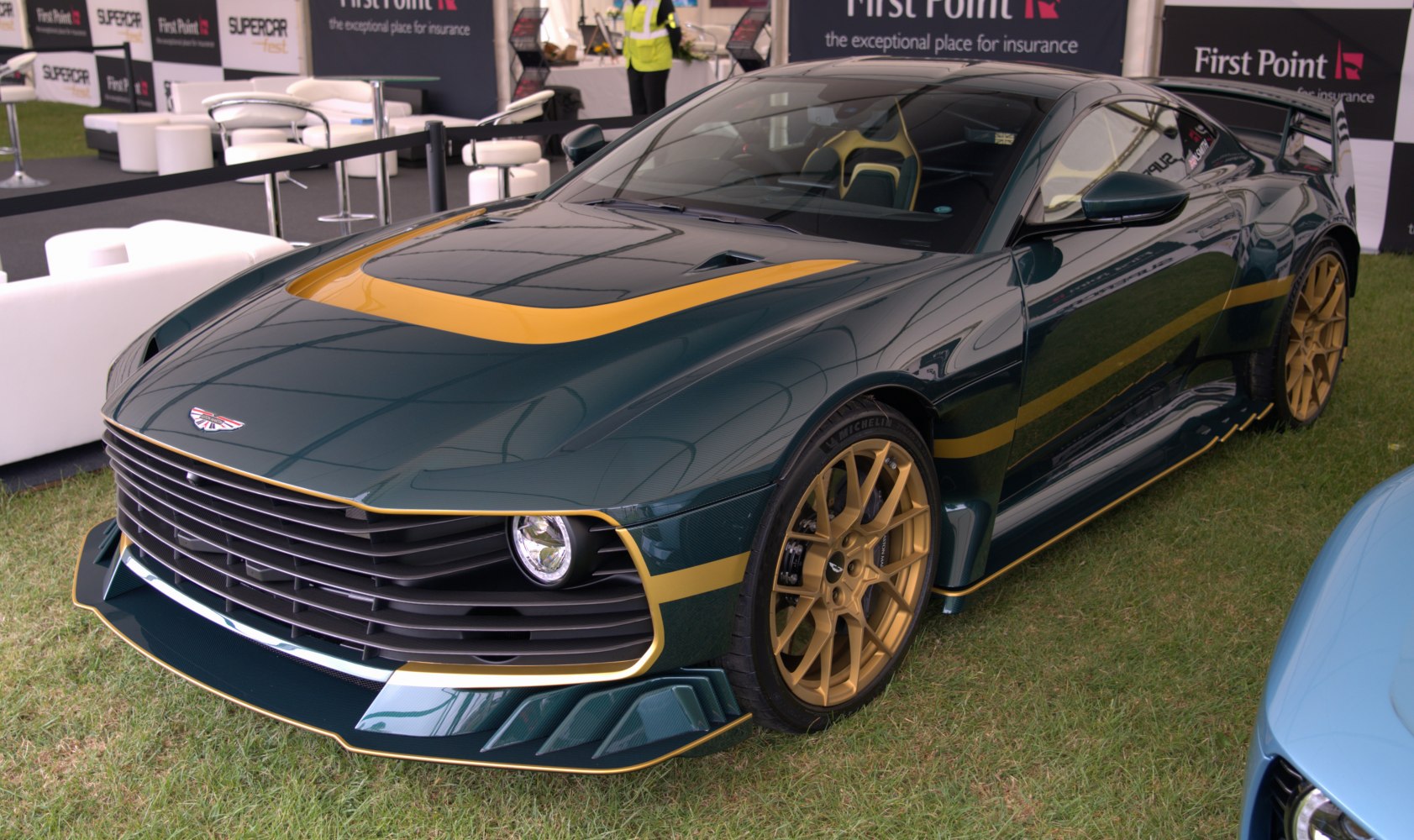 Front grille, aerodynamic body, yellow accent stripes, performance wheels