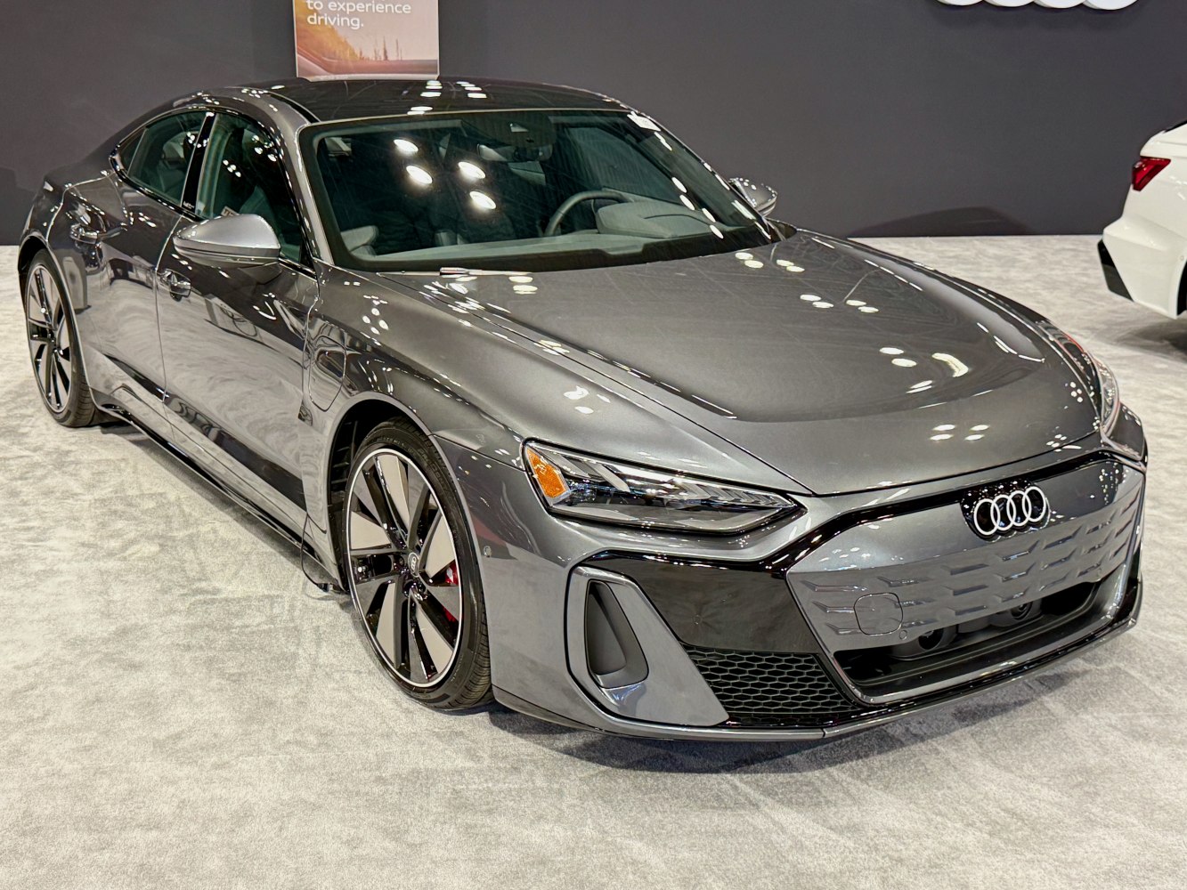 Electric sports sedan with sharp headlights and aerodynamic front.