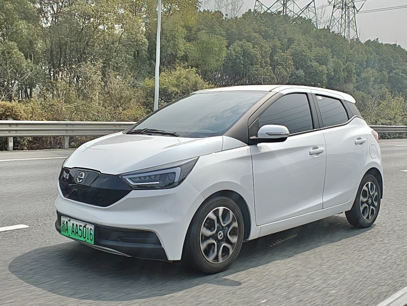 Compact electric hatchback with black grille and LED headlights