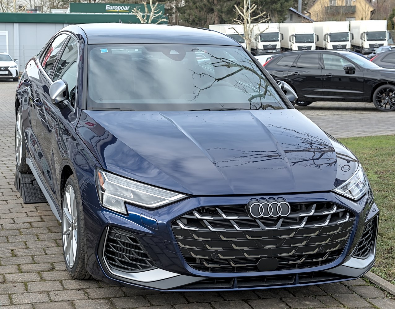 Sporty front grille with sharp LED headlights on a sedan