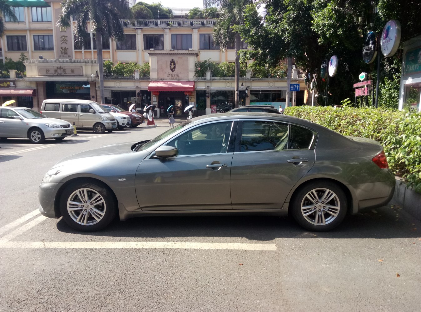 Side profile of a mid-size luxury sedan with alloy wheels and a sleek design.