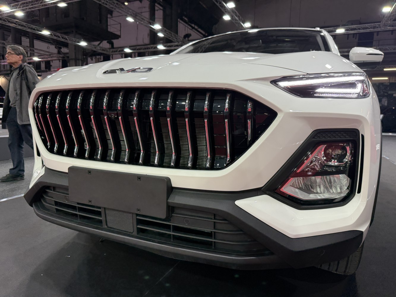 Modern front grille with chrome vertical slats and sleek LED headlights.