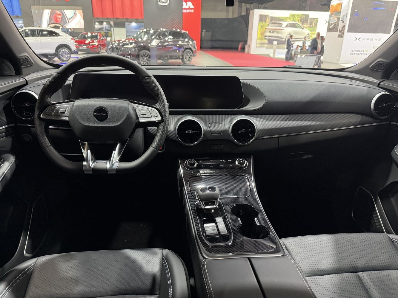 Modern dashboard with dual circular air vents and multifunction steering wheel