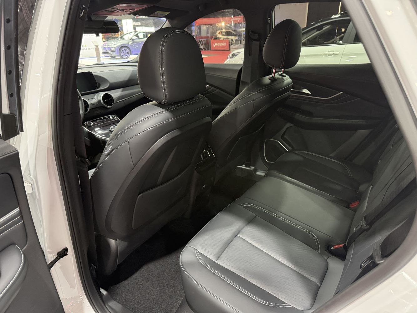 Rear seating and dashboard interior with black leather seats and modern design