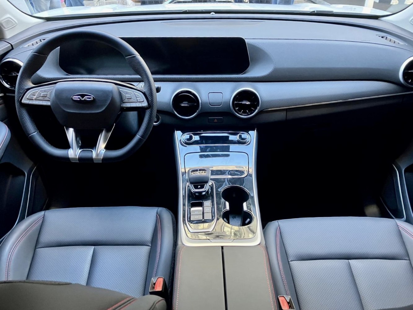 Modern dashboard and steering wheel with sporty seats