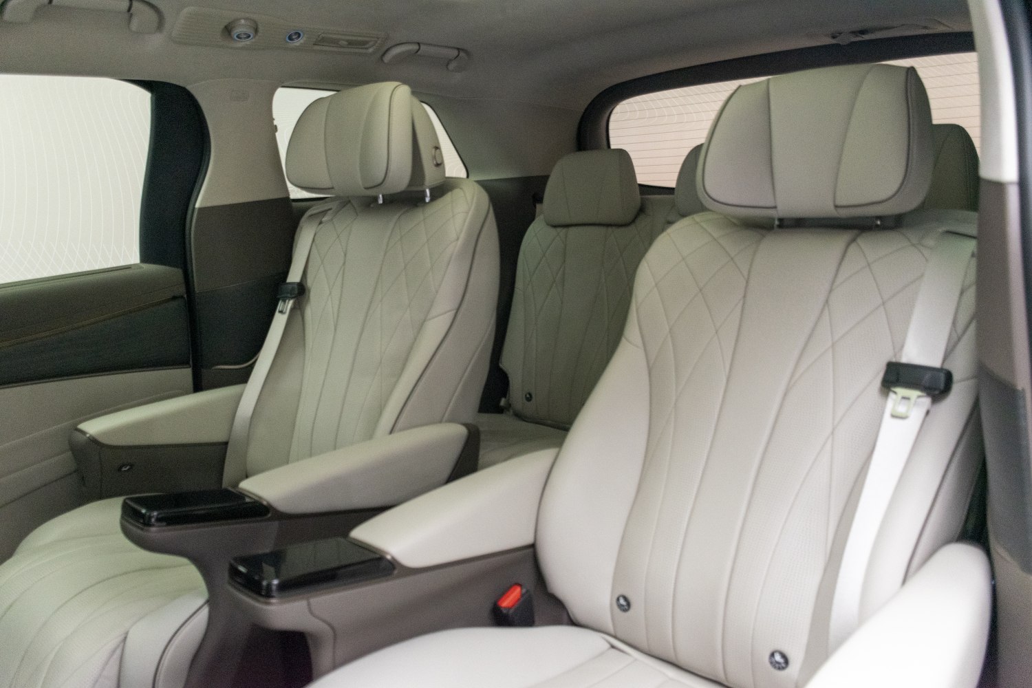 Beige leather seats with diamond stitching and armrests