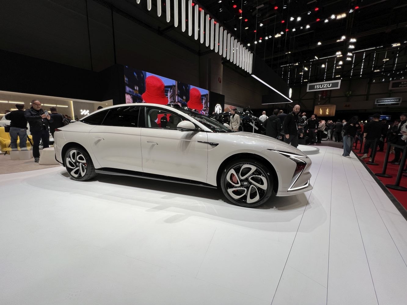 White sedan with aerodynamic body and futuristic alloy wheels.